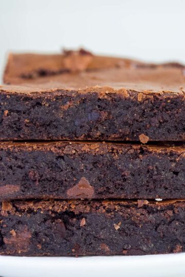 Three rich and fudgy chocolate espresso brownies on a plate