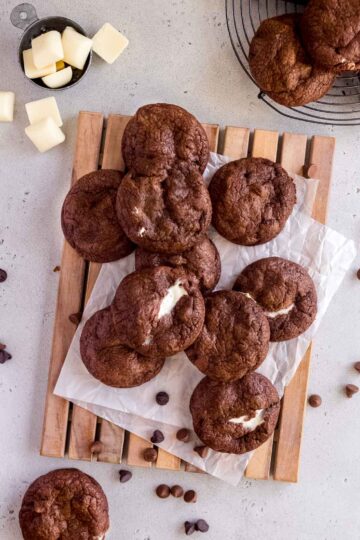 triple chocolate cookies on a wooden tray