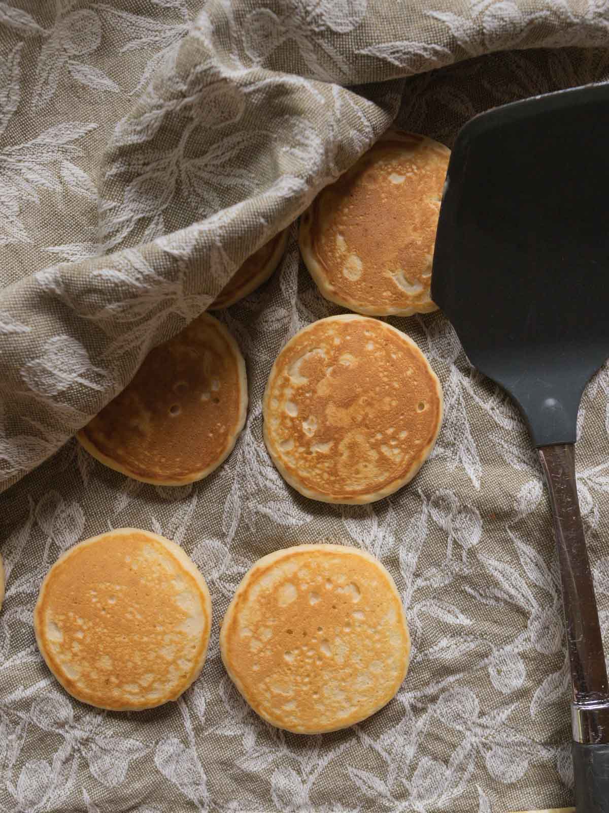 I rest my pikelets on a clean linen tea towel to keep them warm, but to also stop them from steaming and going soggy. 