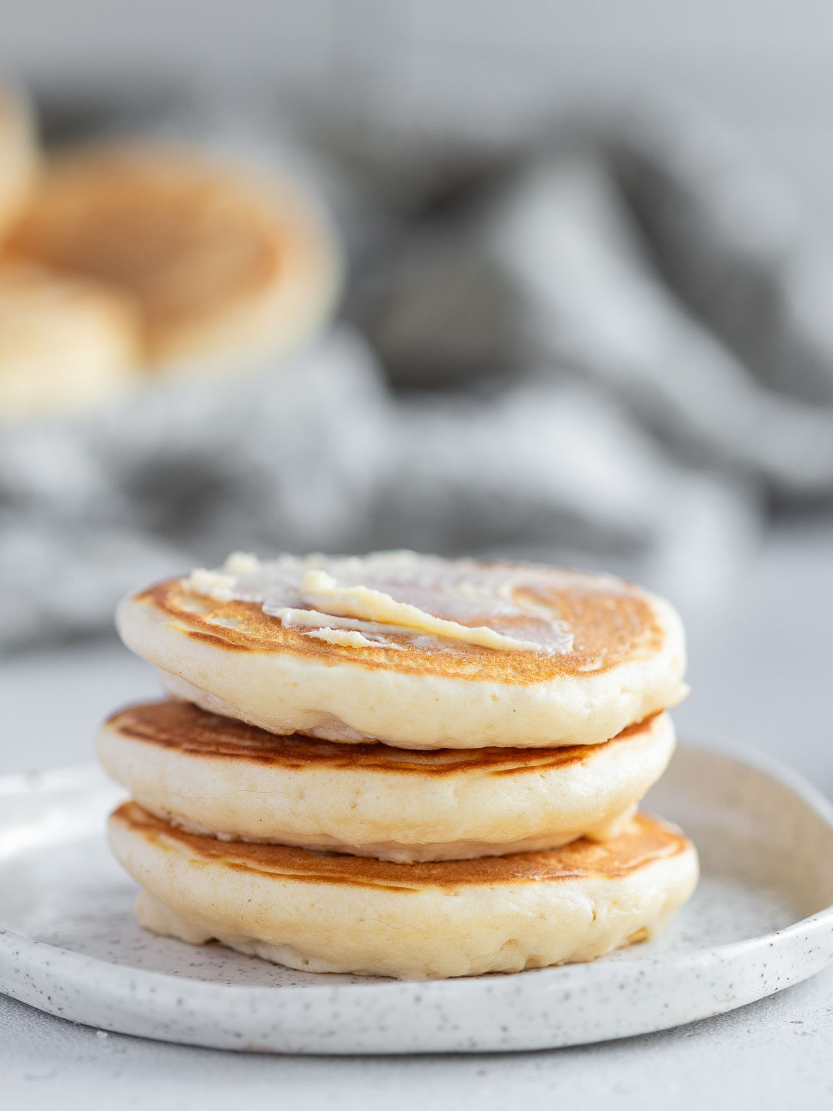 Three little pikelets topped with just a smear of butter.