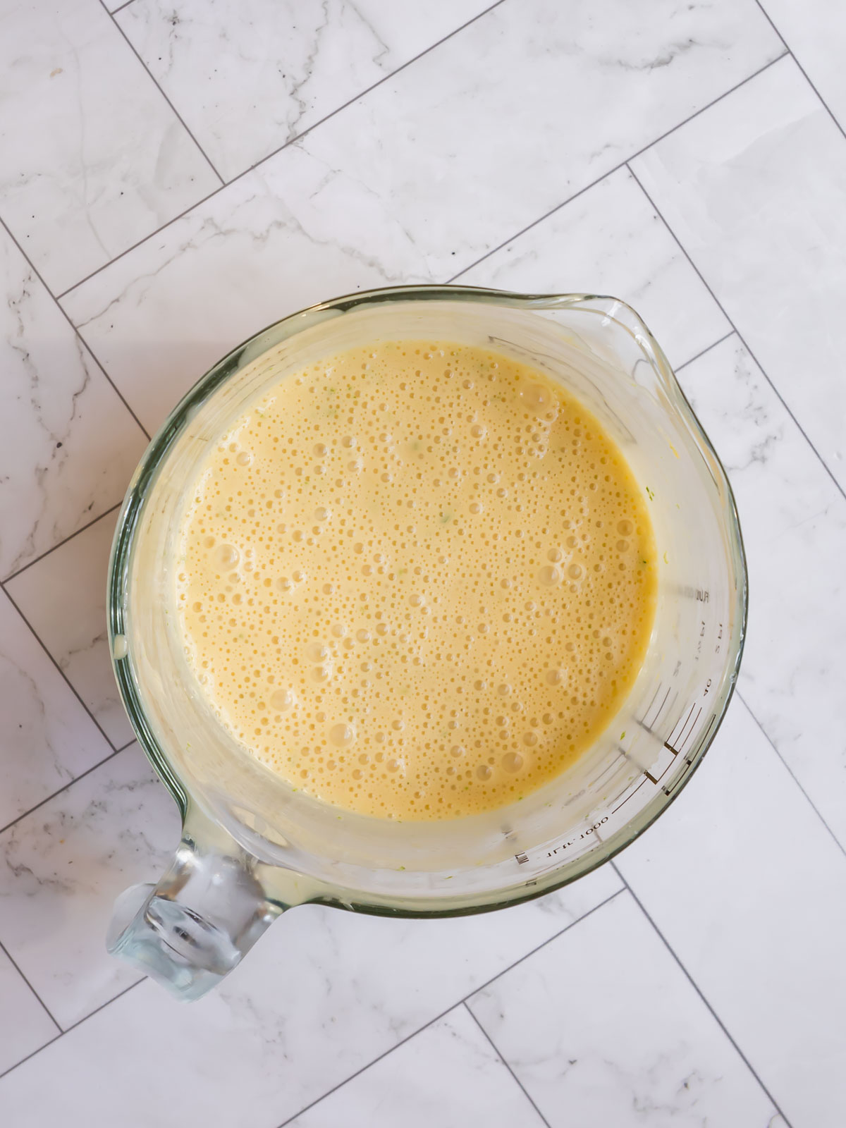 Mixing the filling for the gluten-free Key Lime Pie with sweetened condensed milk, egg yolks, and lime juice