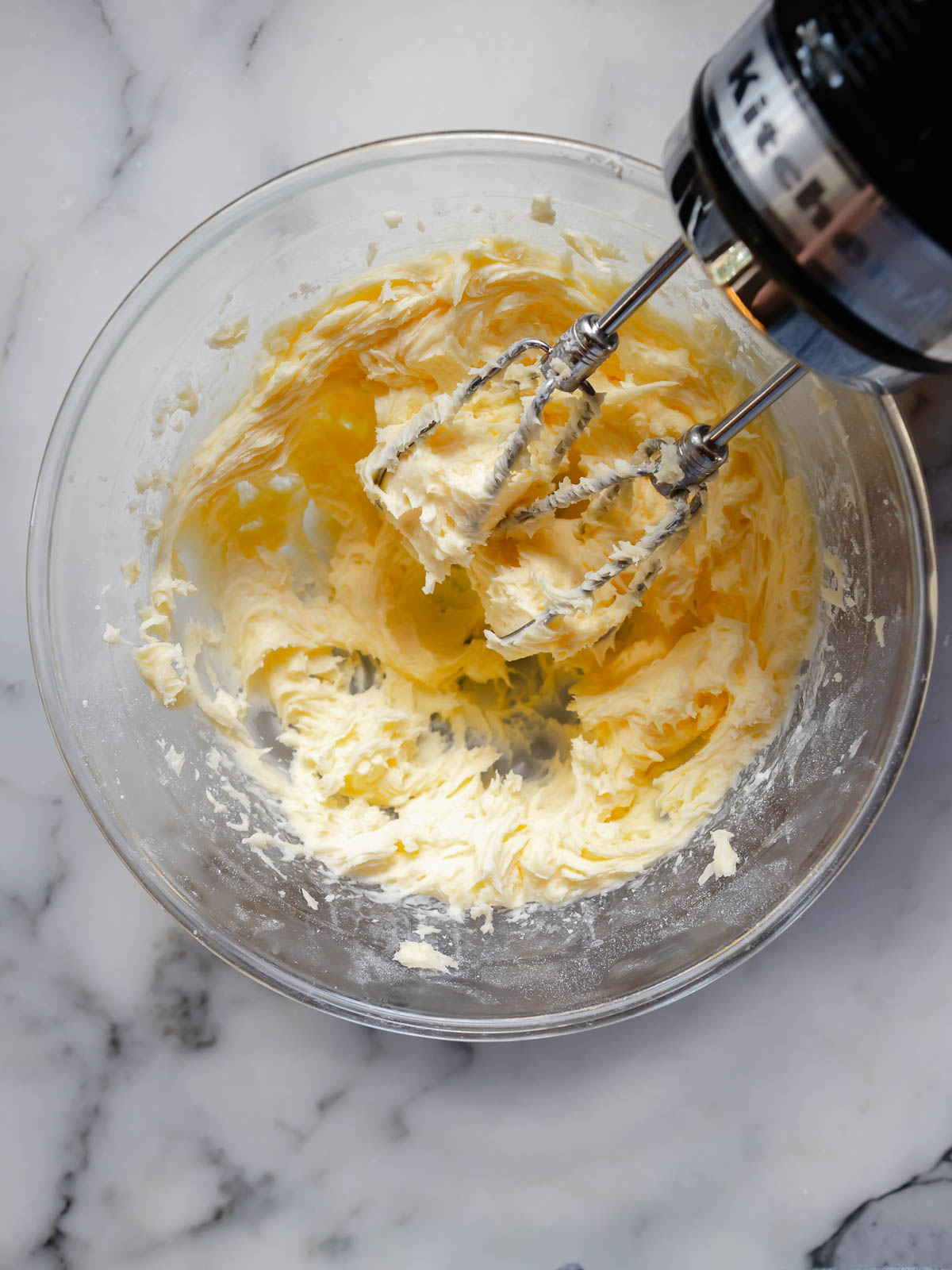Softened butter and icing sugar beaten together until pale and fluffy—first step in making soft sugar cookies