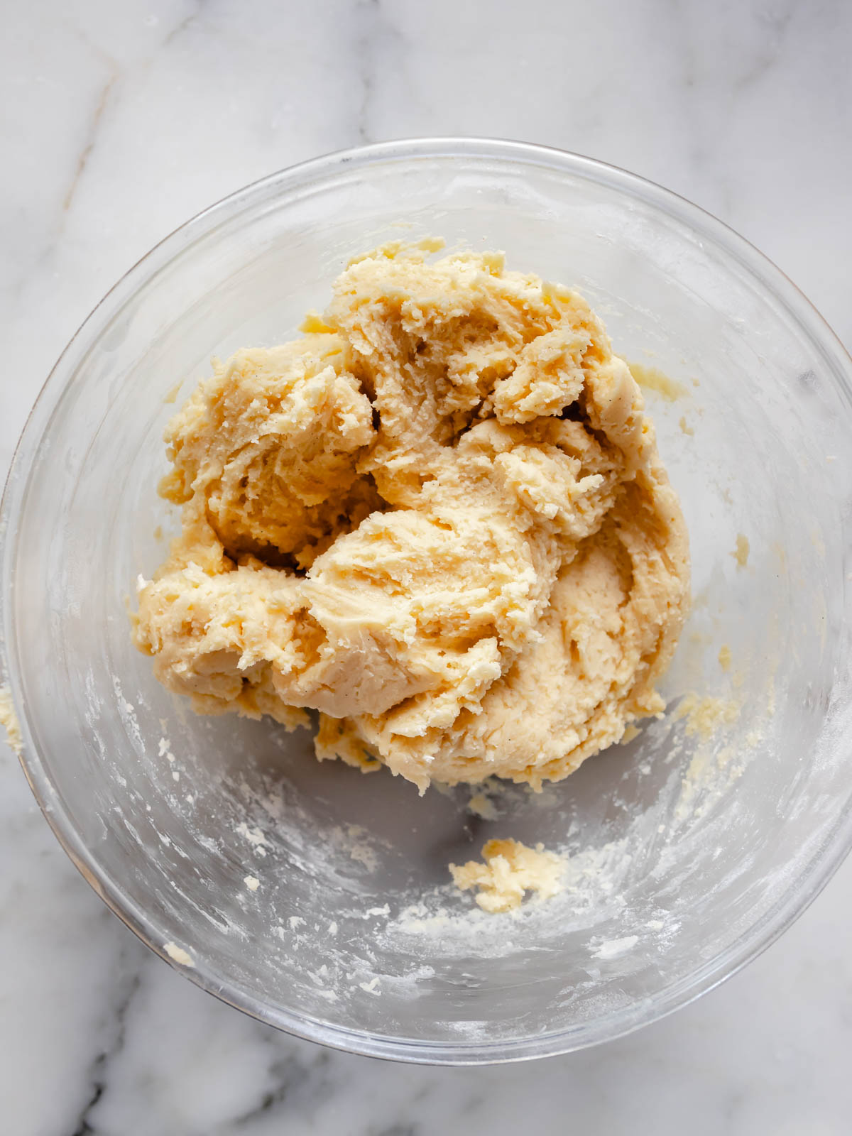 Sugar cookie dough mixed gently with a spatula to avoid overworking—resulting in soft, pillowy cookies.