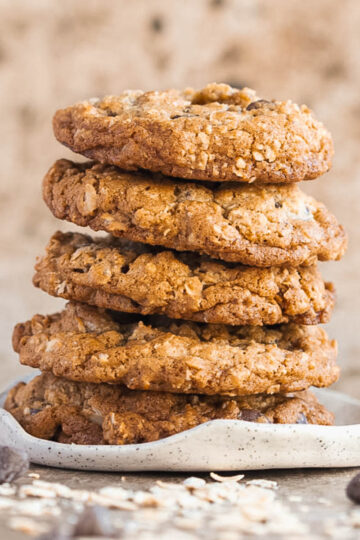 5 browned butter oatmeal cookies stacked on a plate