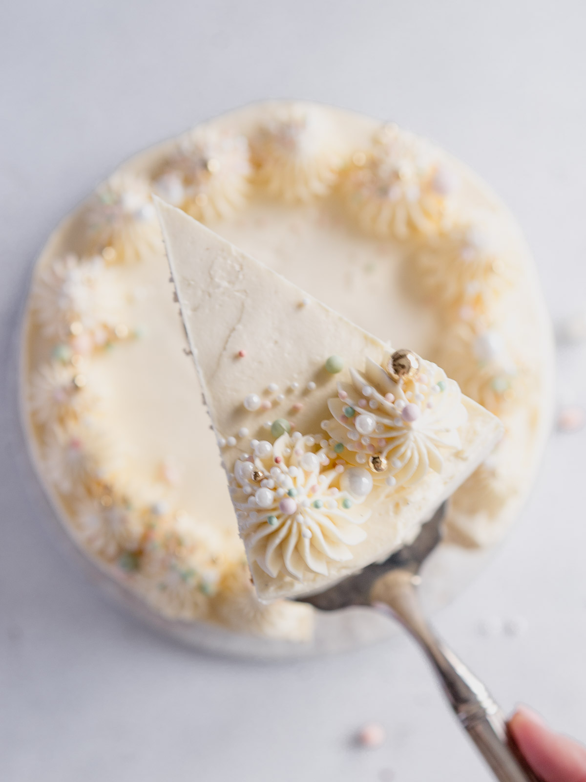 A slice of a 3 layer vanilla cake.