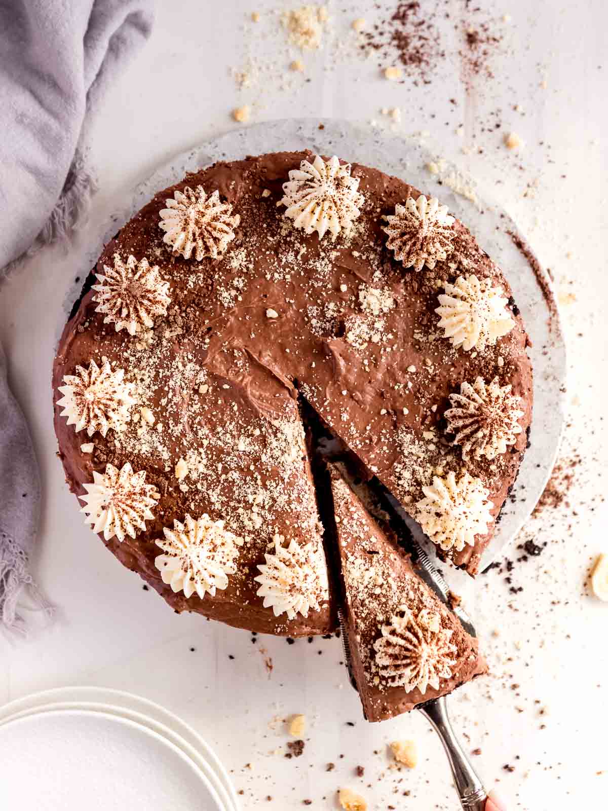 A decorated and sliced chocolate and banana cheesecake.