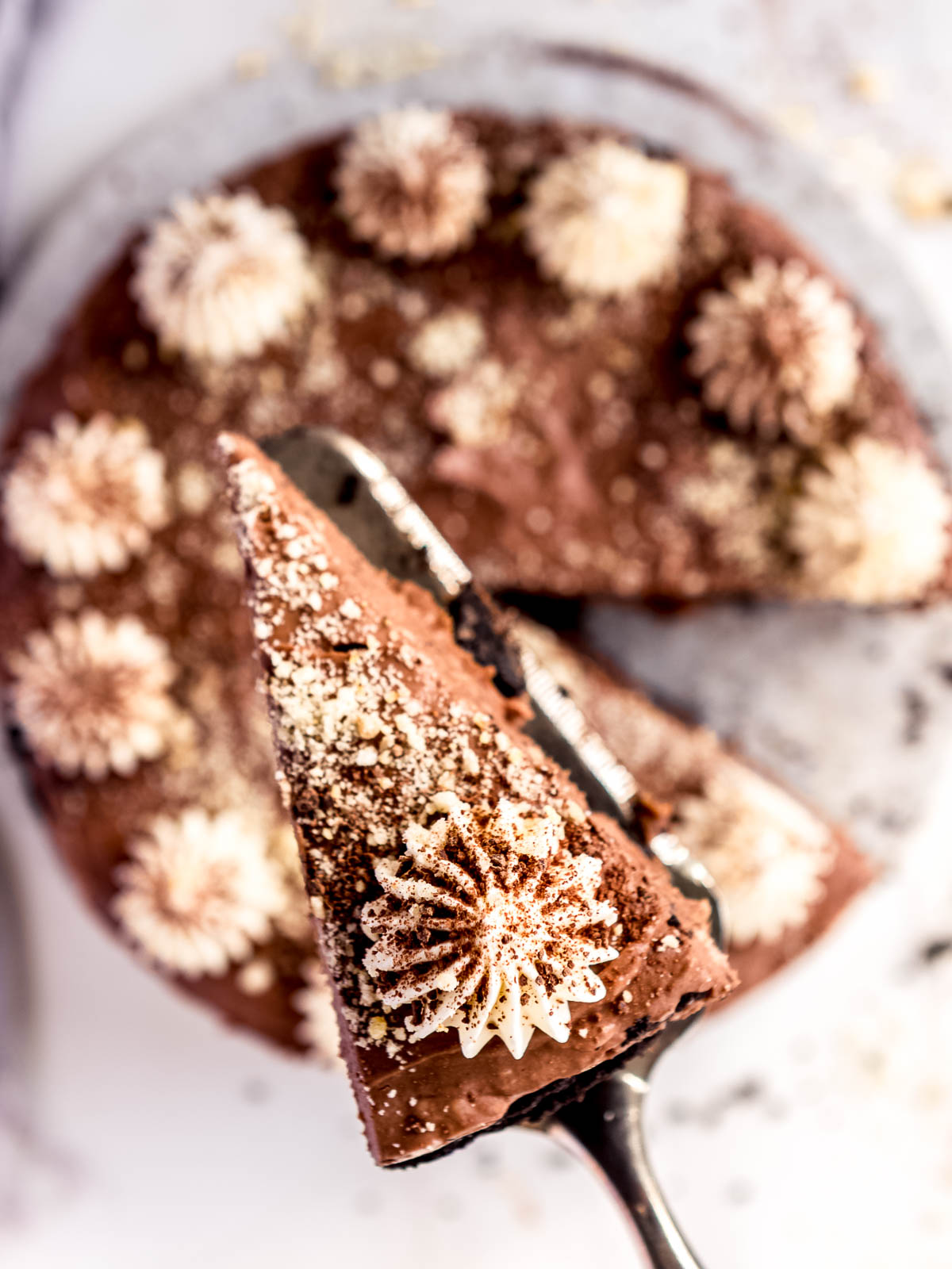 A decorated and sliced chocolate and banana cheesecake.