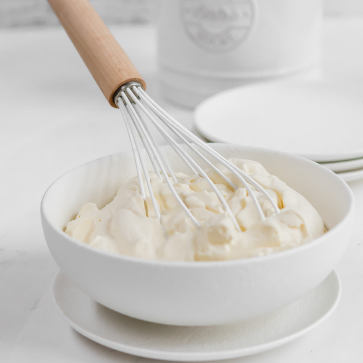 Whisking a bowl of Chantilly cream.