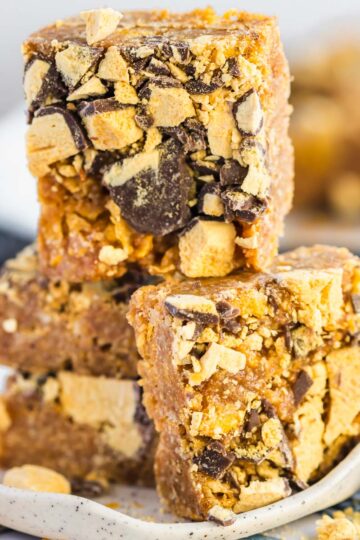 Four squares of honey joy slice on a plate.