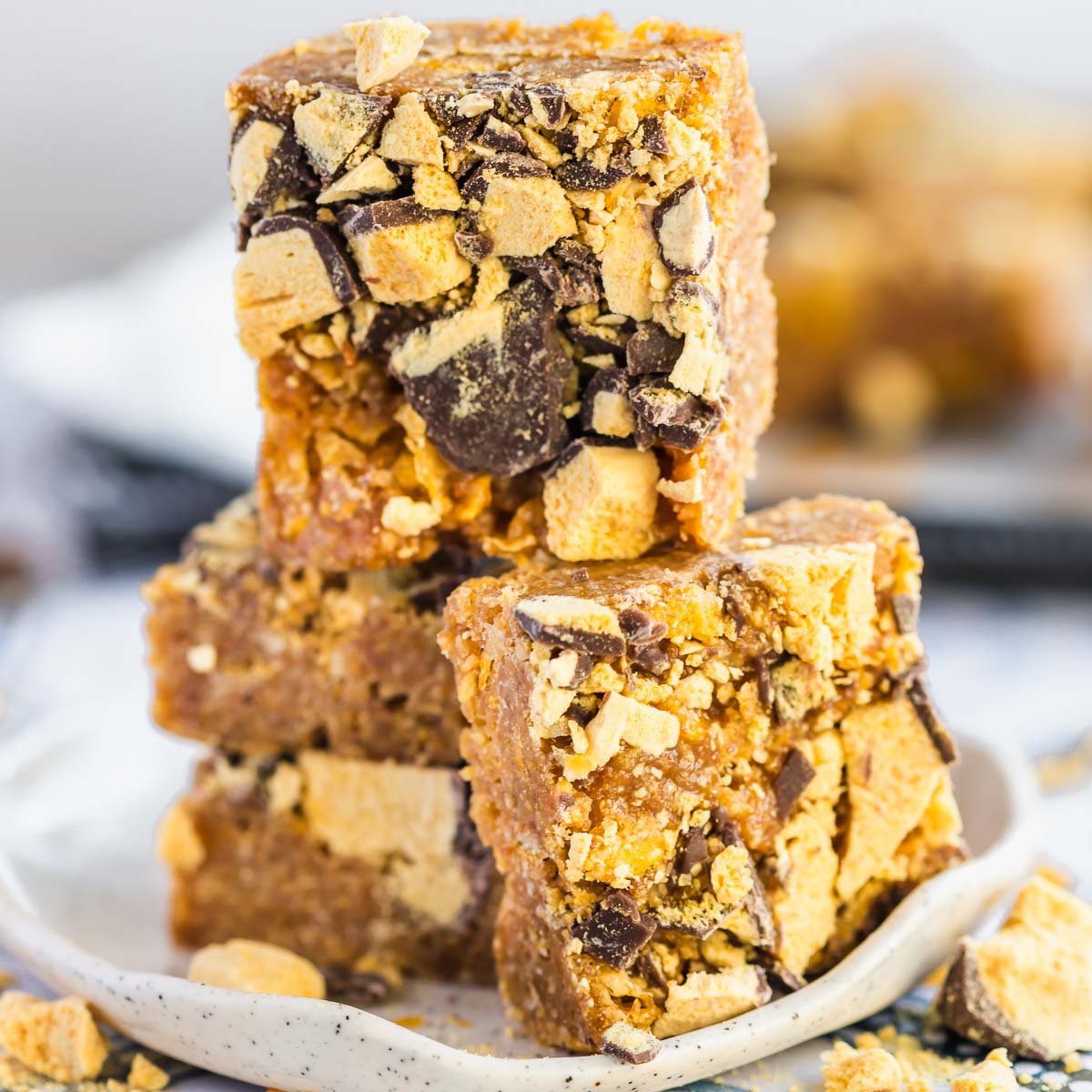 Four squares of honey joy slice on a plate.