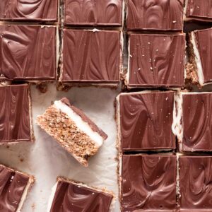 Chilled no-bake peppermint slice is cut into neat squares, using a hot knife.