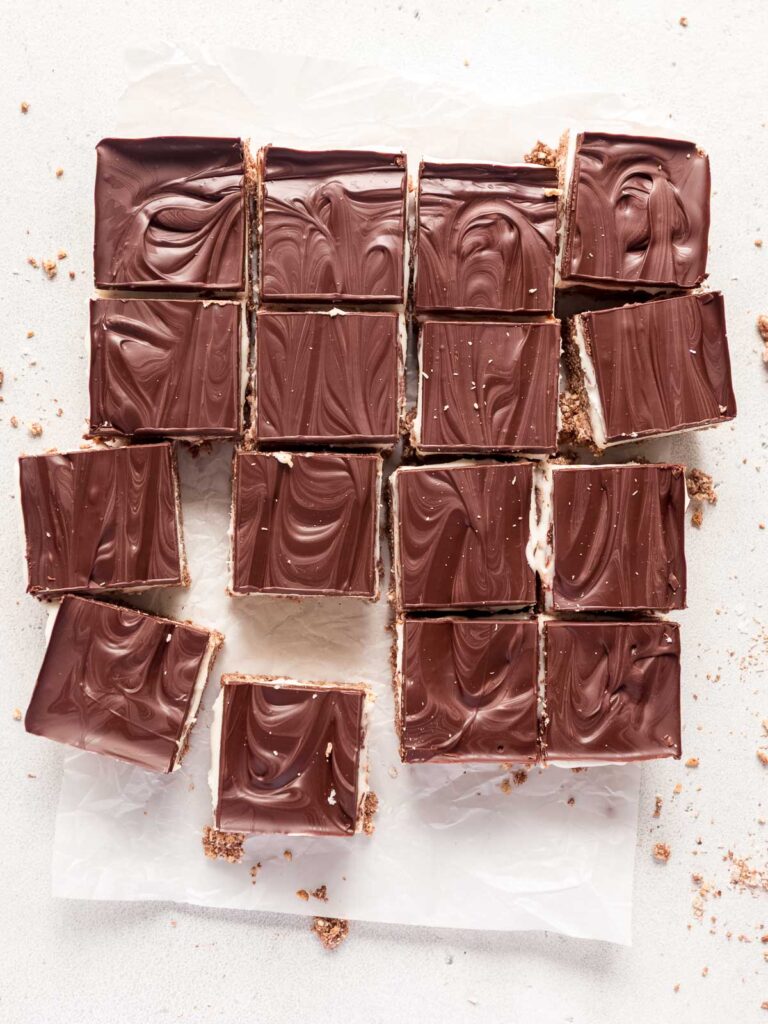 Chilled no-bake peppermint slice is cut into neat squares, using a hot knife.