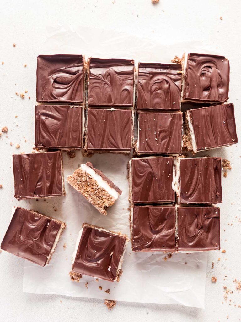 Chilled no-bake peppermint slice is cut into neat squares, using a hot knife.