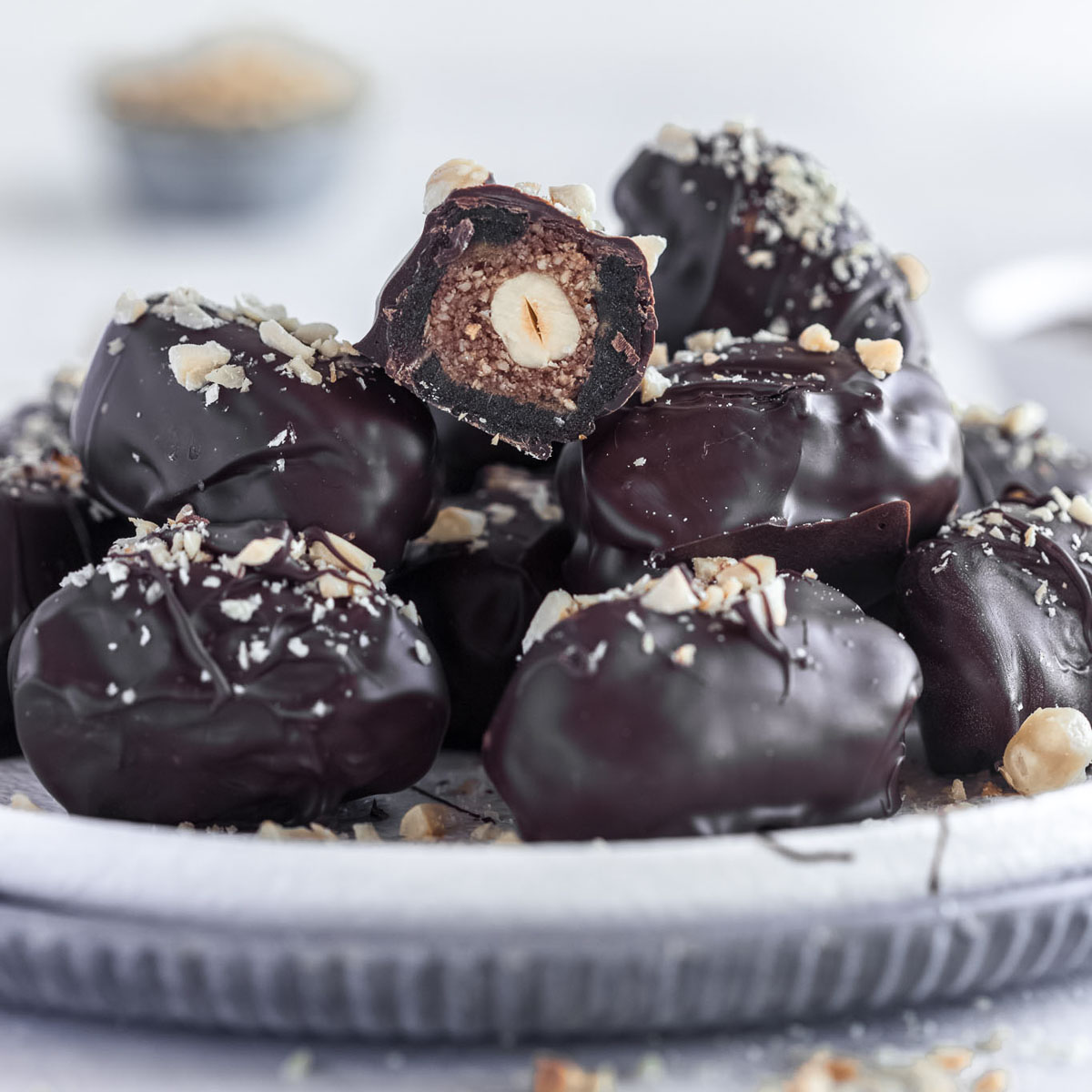 A plate of chocolate coated dates, with a hazelnut filling