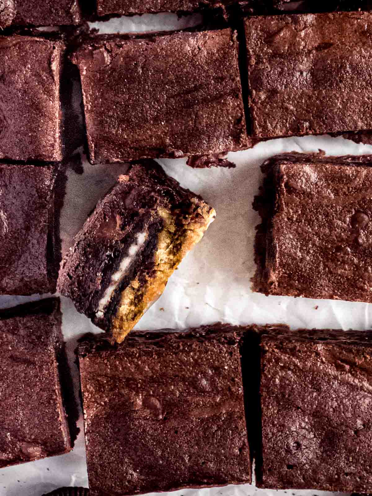 Baked triple layer brownies, cooled and cut into slices.