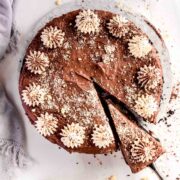 A silky chocolate banana cheesecake slice being served.