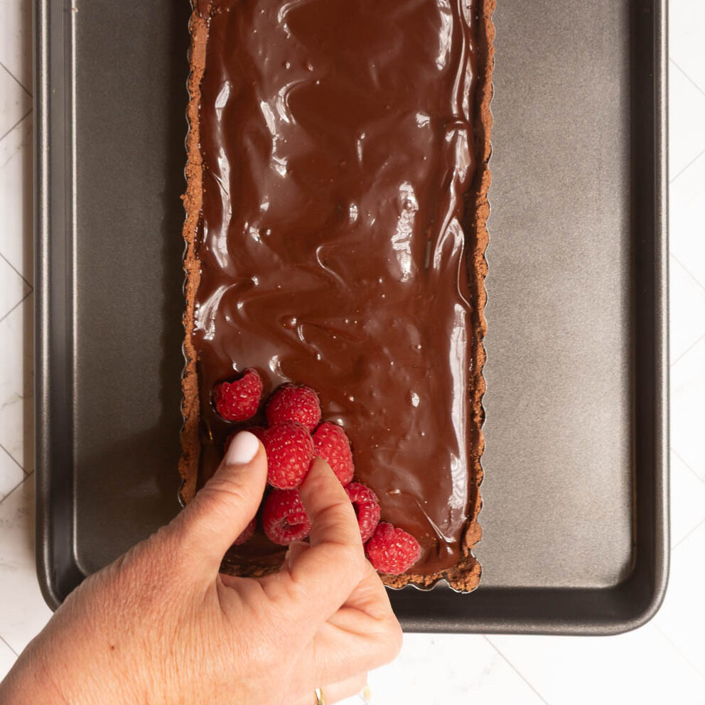 Process shot for a chocolate and raspberry tart.