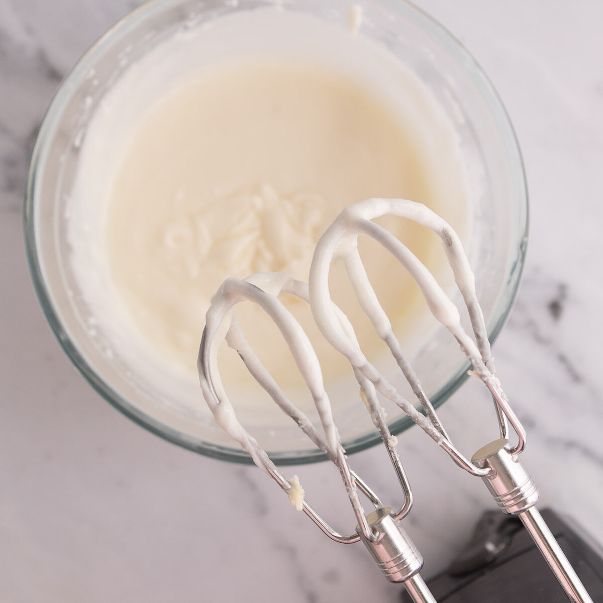 Making the creamy lemon icing to spread over the lemon coconut slice.