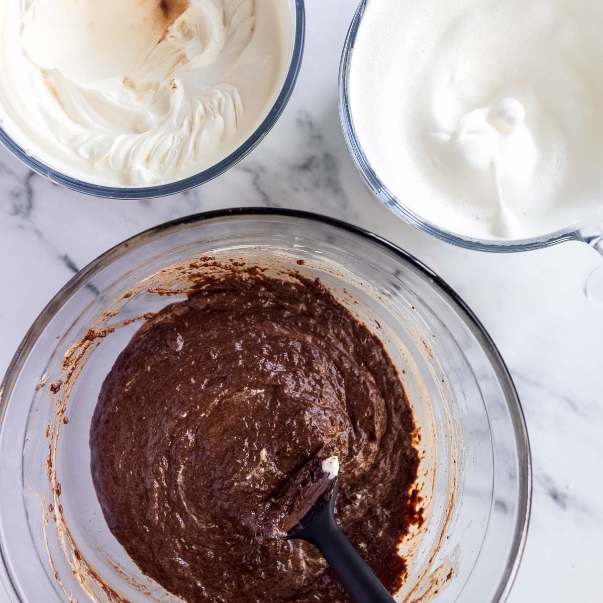 Making toblerone mousse, by folding through whipped eggwhites and whipped cream.