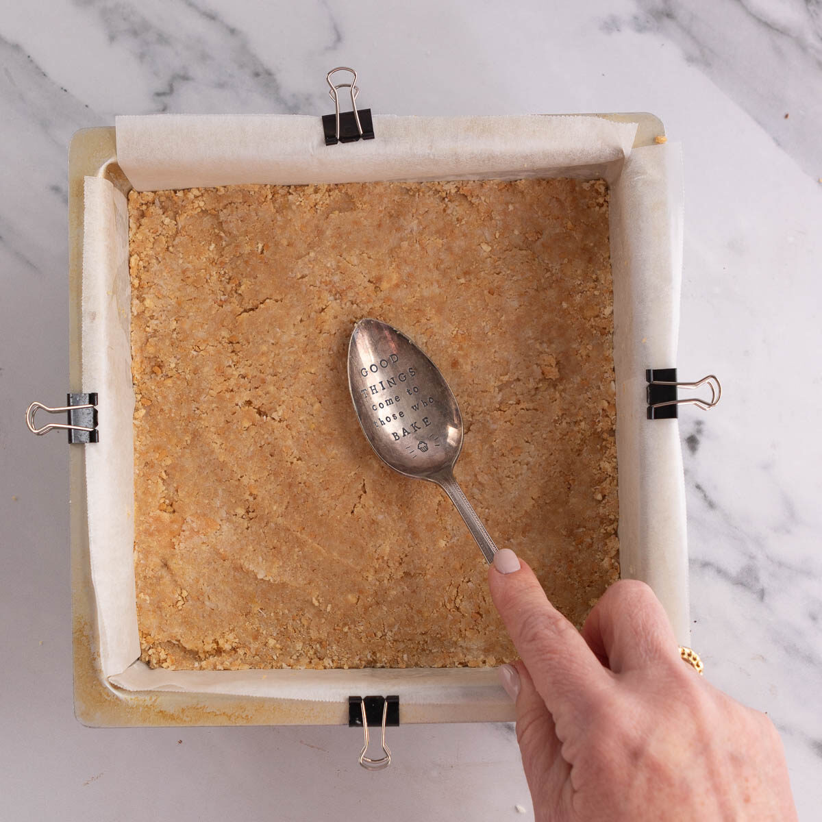 Use a large spoon or offset spatula to spread the lemon biscuit mixture into a apn.