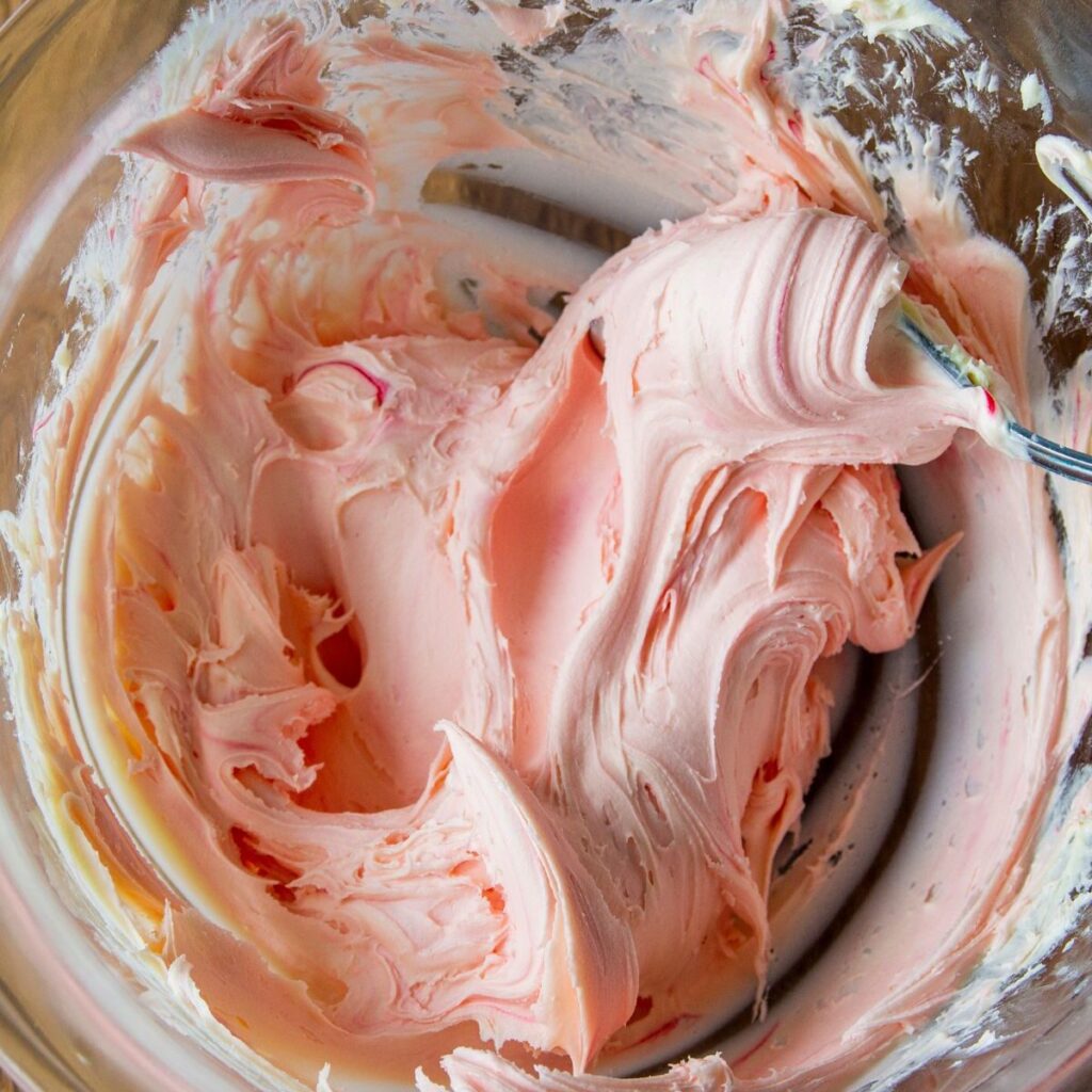 Making the fresh strawberry frosting for the mini chocolate cakes.