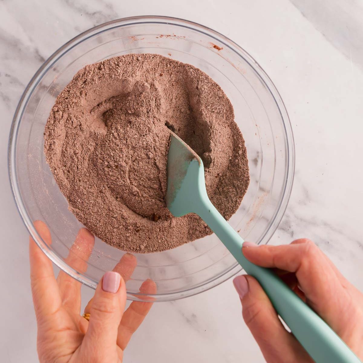 Combining the dry ingredients to make mini chocolate cakes