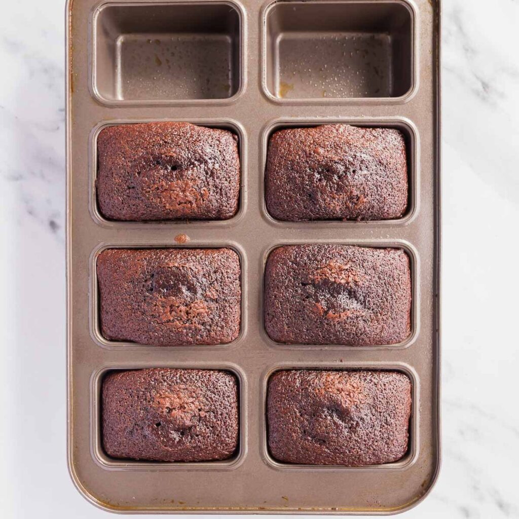 Baking mini chocolate cakes in a mini loaf tin.