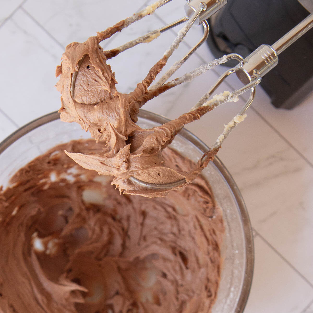 Beat frosting mixture for the chocolate hedgehog slice until fluffy.
