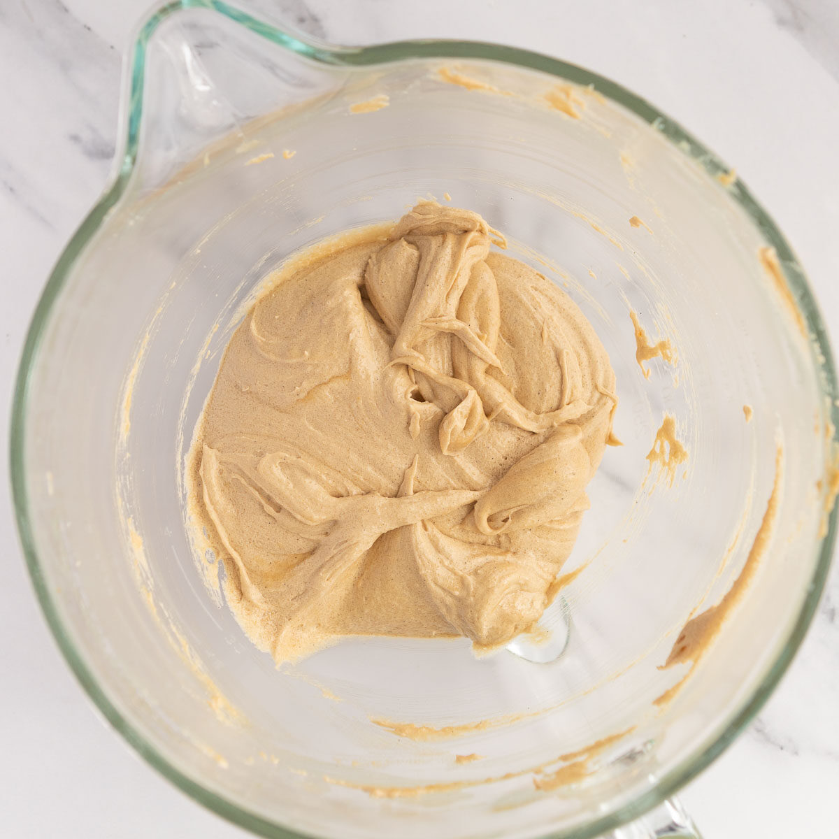 Creaming the sugar and butter and then adding egg and vanilla to make no chill chocolate chip cookies.