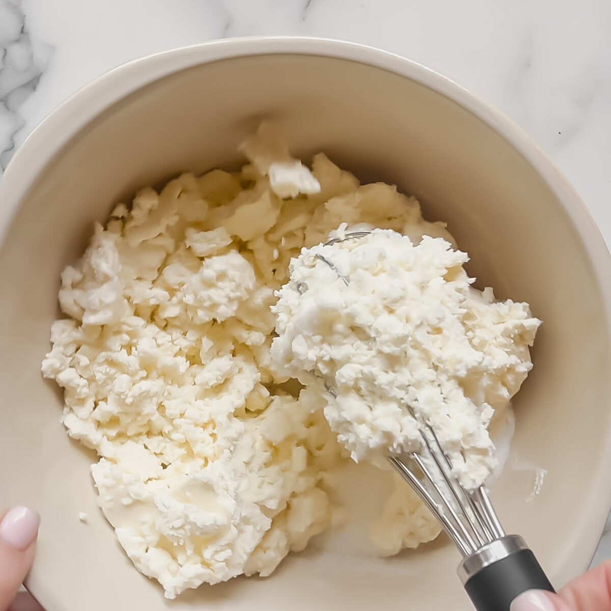 Mixing the ricotta and sugar by hand, to make a creamy tiramisu.