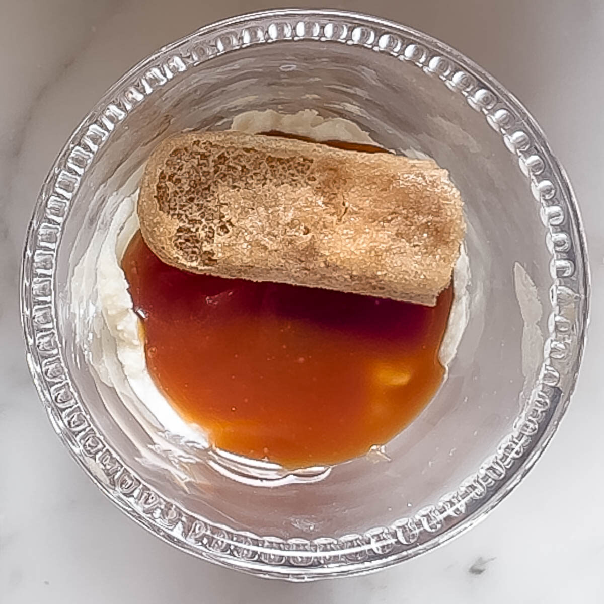 Layering the elements to make a caramel tiramisu.