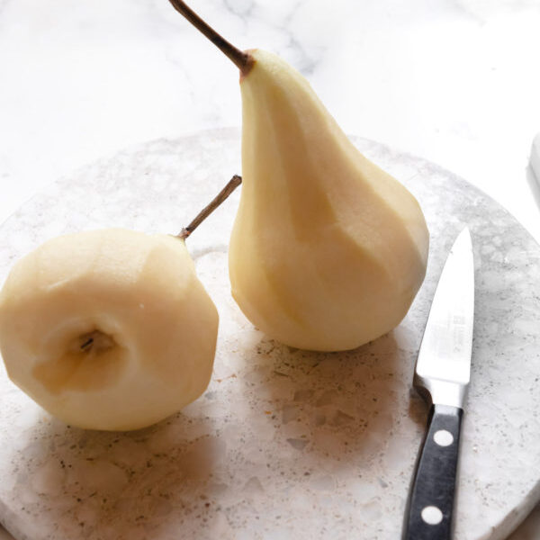 Peeling the pears and removing the hard core from the bottom.