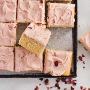 A soft and fluffy vanilla sheet cake with pink strawberry buttercream.