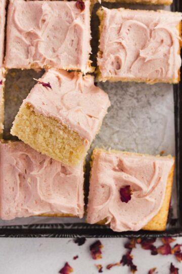A soft and fluffy vanilla sheet cake with pink strawberry buttercream.