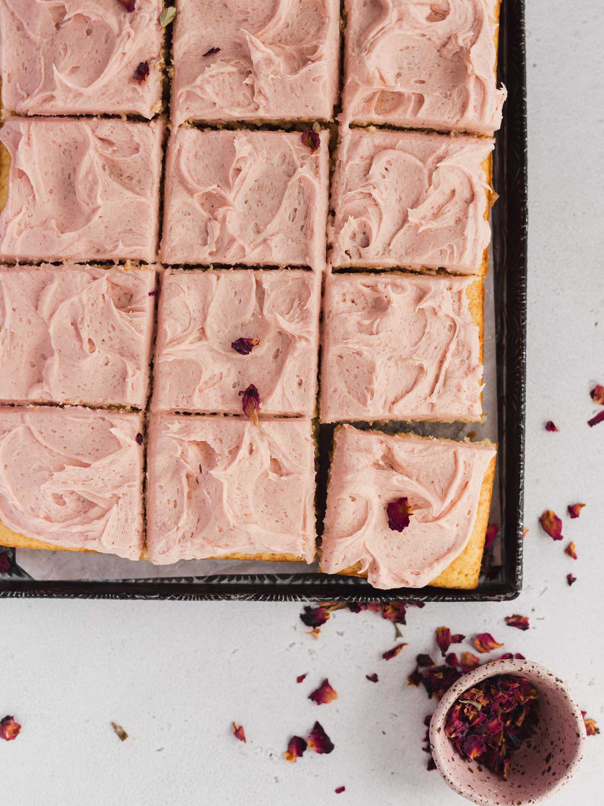 A soft and fluffy sheet cake, made in a tray and frosted with strawberry buttercream.