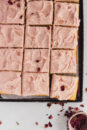 An easy tray bake; this vanilla sheet cake is moist and tender. Topped with strawberry buttercream.