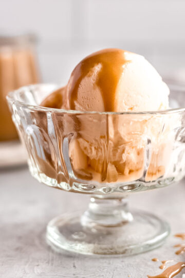 Rich and fudgy butterscotch sauce poured over vanilla ice cream.