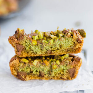 Dubai chocolate chip cookie cut in half to show the rich kataifi and pistachio filling.