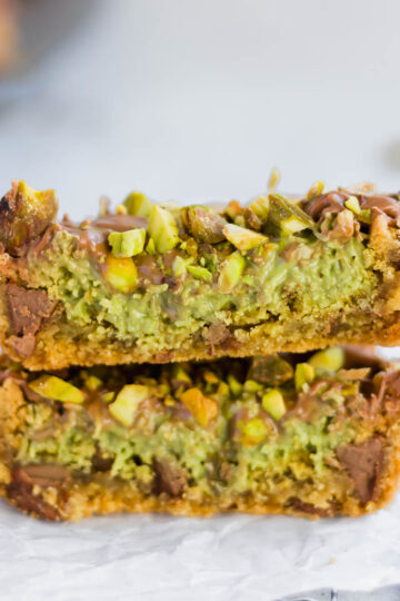 Dubai chocolate chip cookie cut in half to show the rich kataifi and pistachio filling.