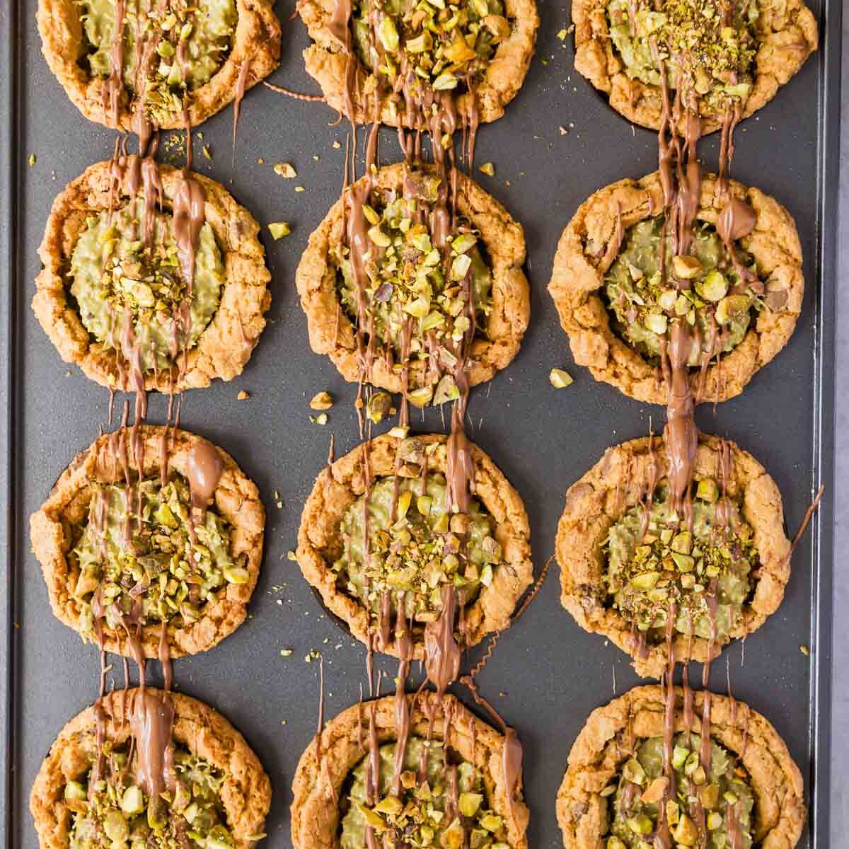 Finished Dubai chocolate chip cookies, filled with pistachio mixture and drizzled with chocolate and pistachios.
