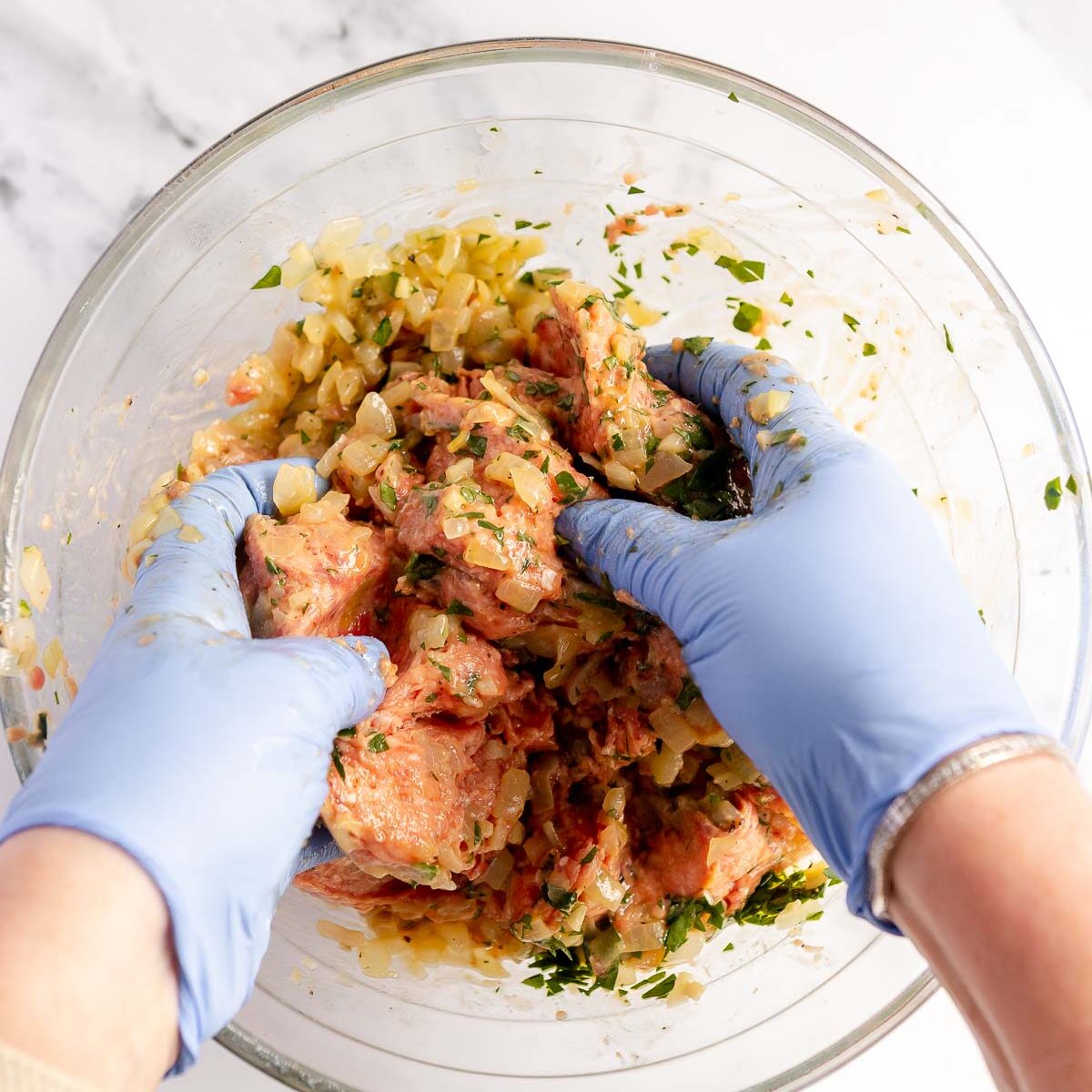 Use food safe gloves to easily mix the sausage roll ingredients.