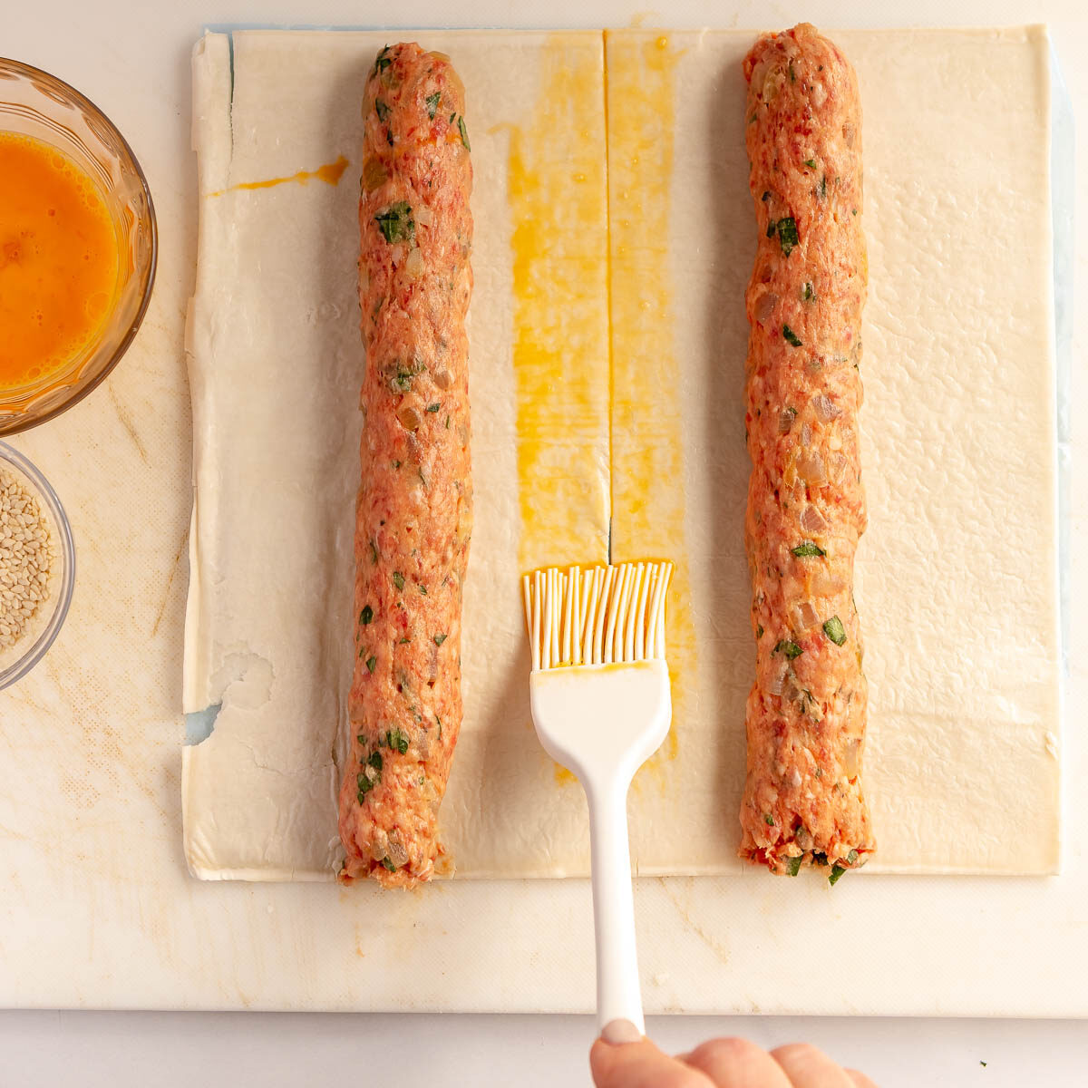 Cut pastry in half, then brush the centre with egg wash.