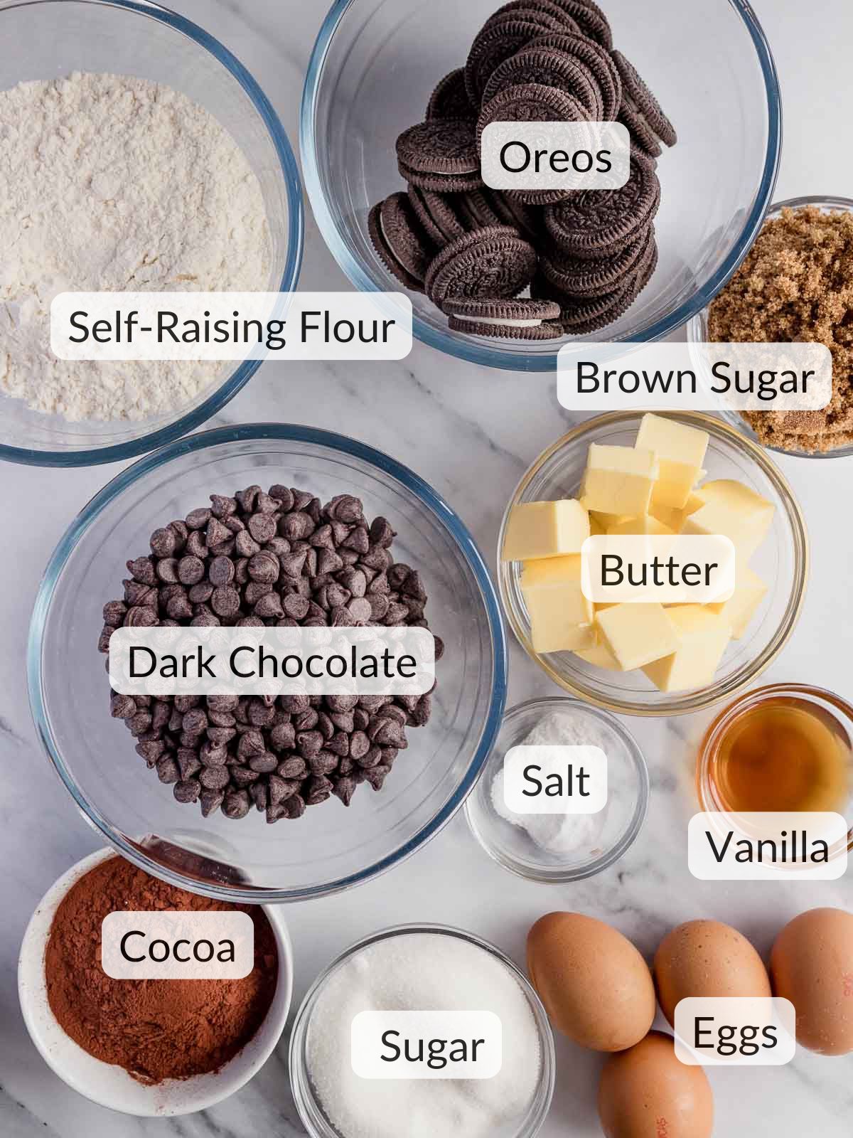 Ingredients needed to make fudgy chocolate brownies with cookie dough and oreos.