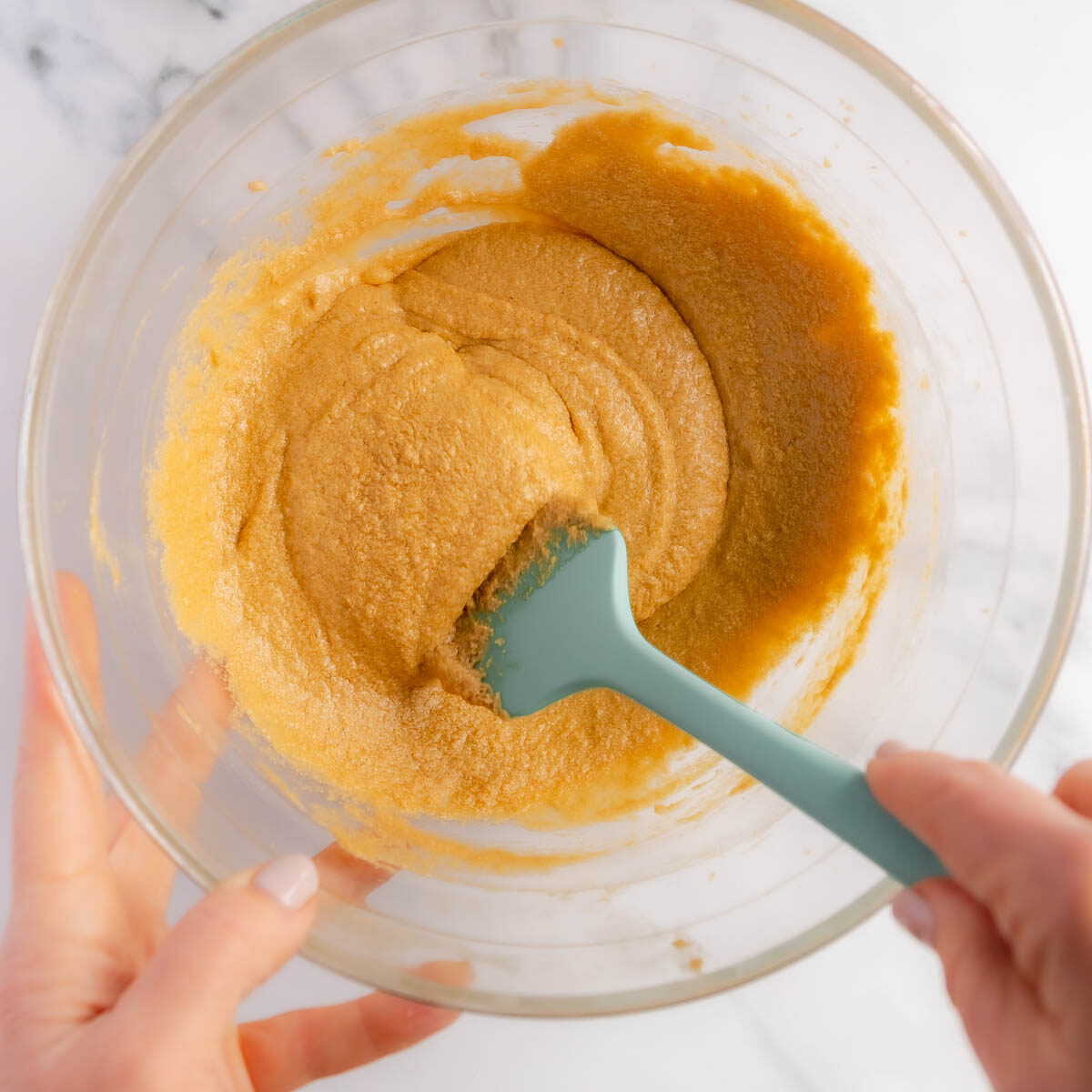 Creaming the butter and sugar, then adding vanilla and eggs.