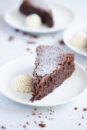 A slice of chocolate fudge cake, served with chantilly cream.