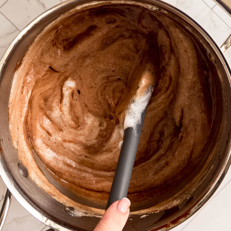 Adding whisked eggwhites and sugar (a meringue) to the chocolate mixture. This is how to make your chocolate cake extra fudgy and delicious.