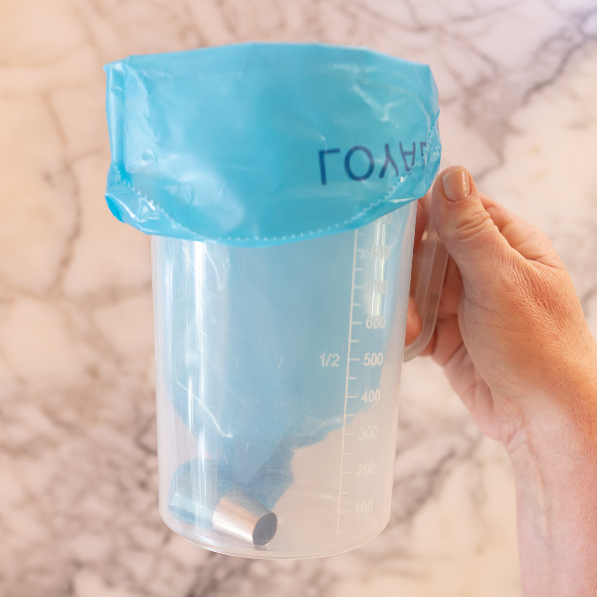 How to place your piping bag in a tall jug, to easily fill it with your macaron batter.