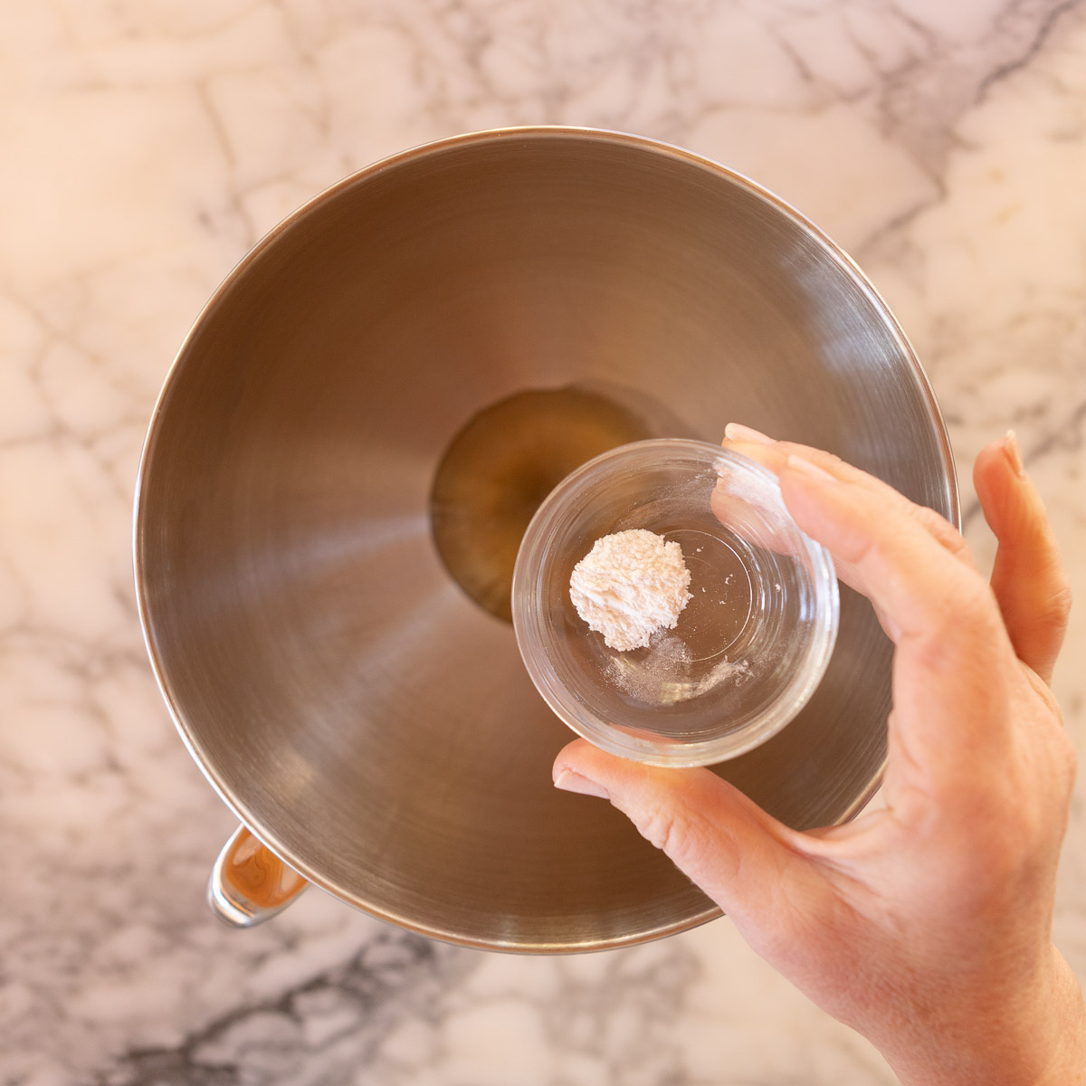 Adding cream of tartar to egg whites, to whip meringue.