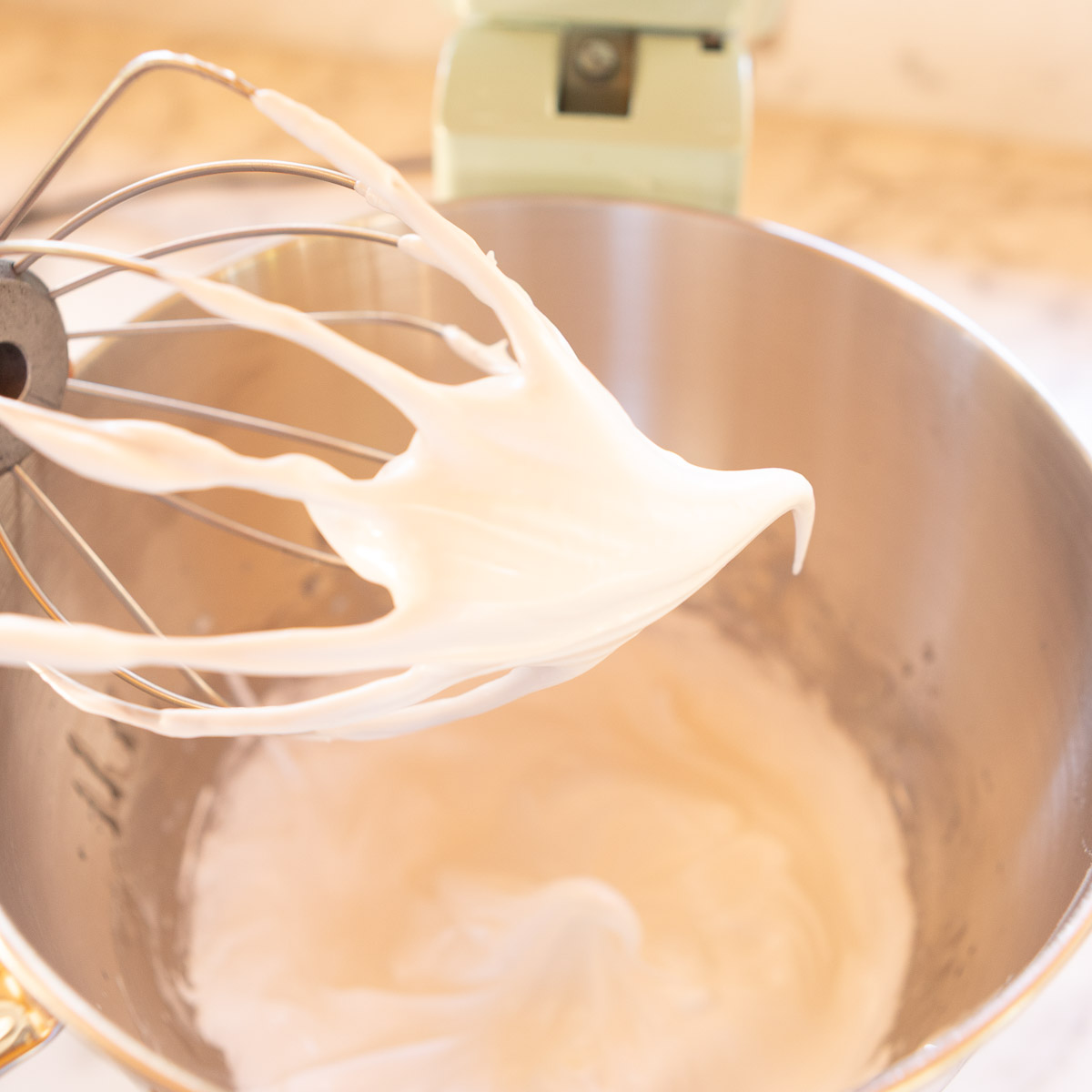 Italian meringue is whipped until glossy and stiff.