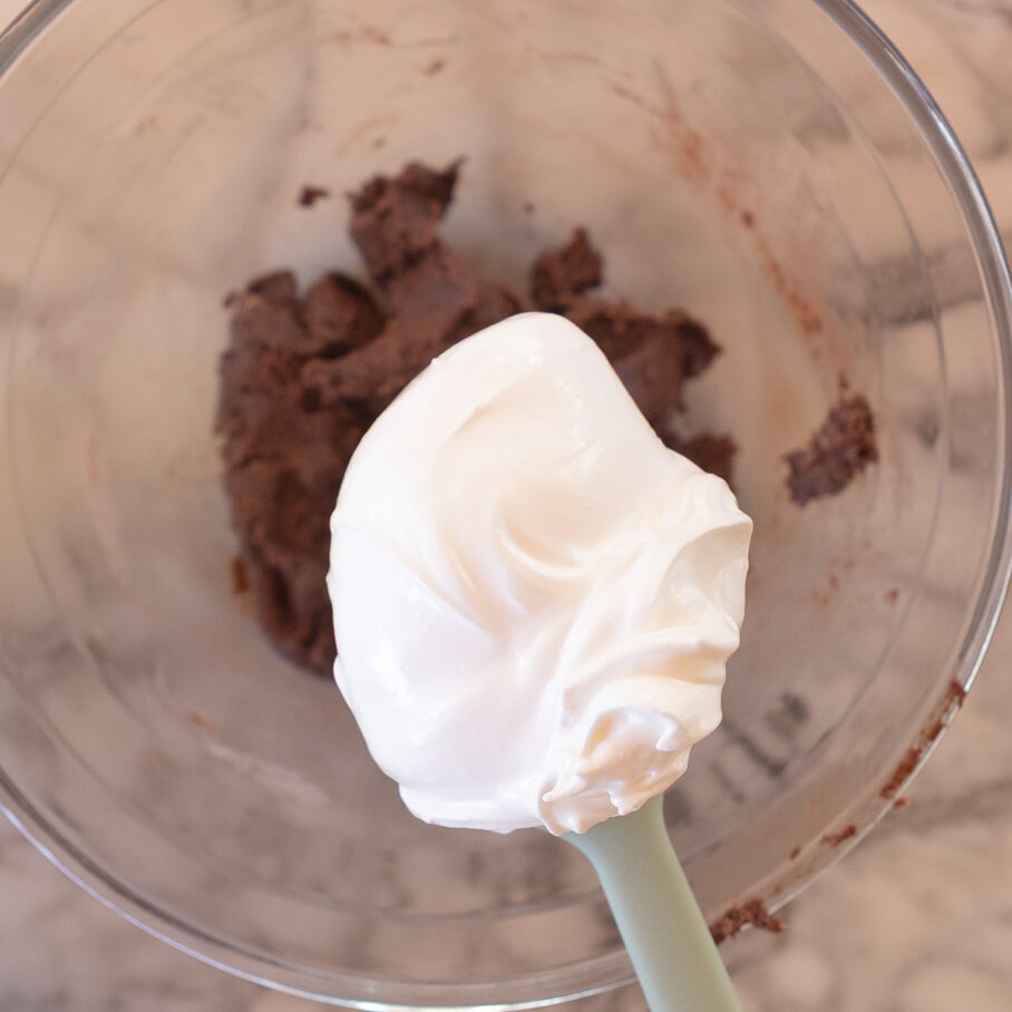 Adding a small amount of Italian meringue to the macaron paste, to loosen the paste.